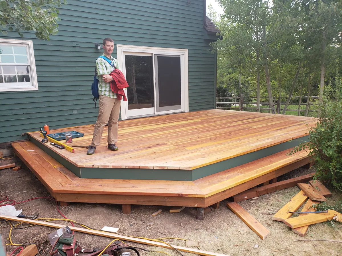 Finished cedar deck showing full scope with homeowner for scale